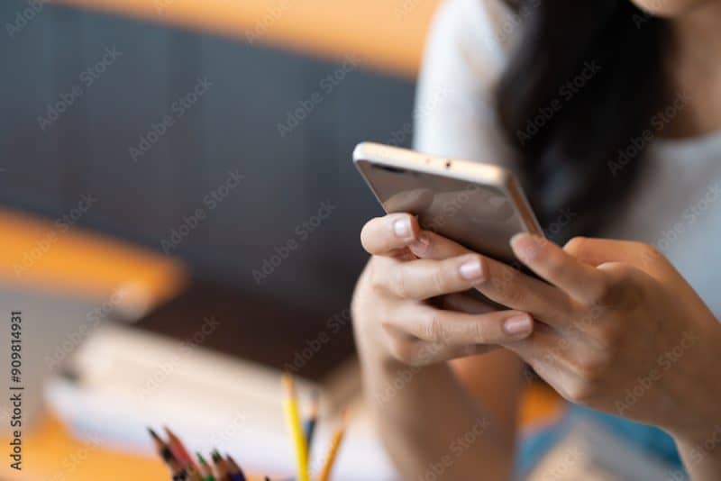 Asian university female using smart phone