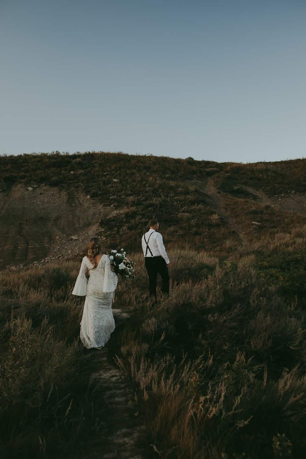 couple walking through the hoodoos in drumheller