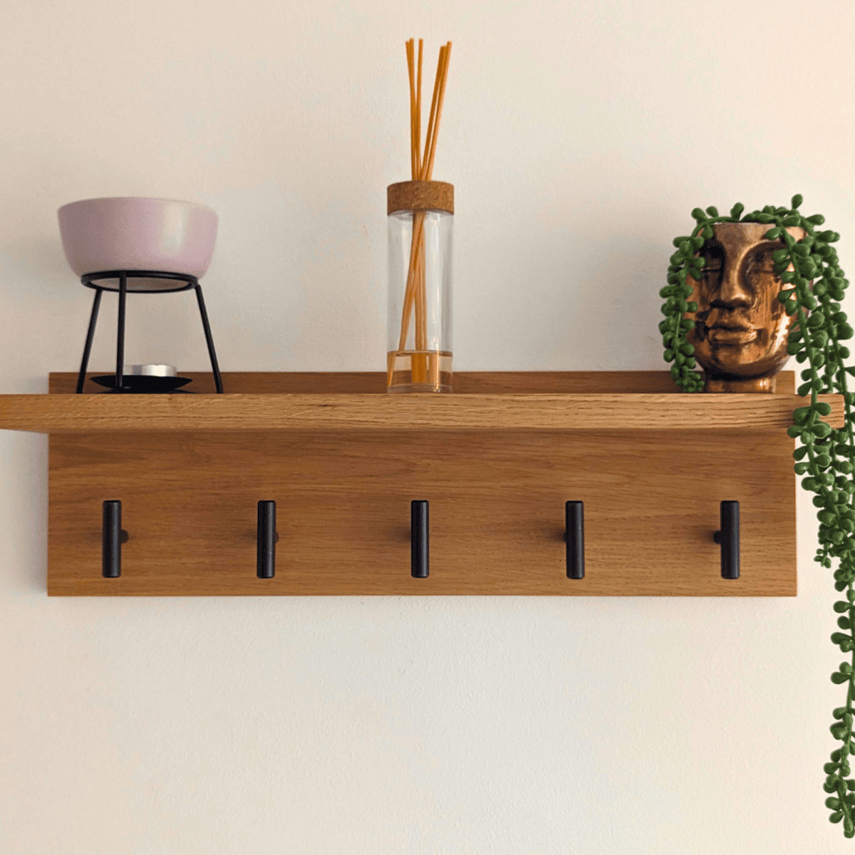 Solid Oak Coat Rack With Shelf - straight view with black hooks and ornaments
