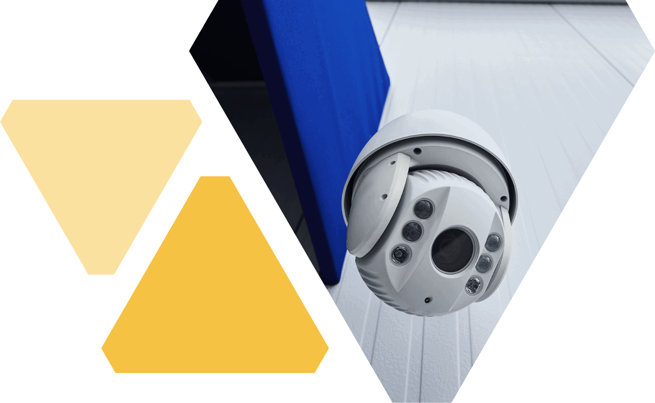 Close view of overhead white, round camera with one large lens in the center, and 3 smaller lenses on either side of it